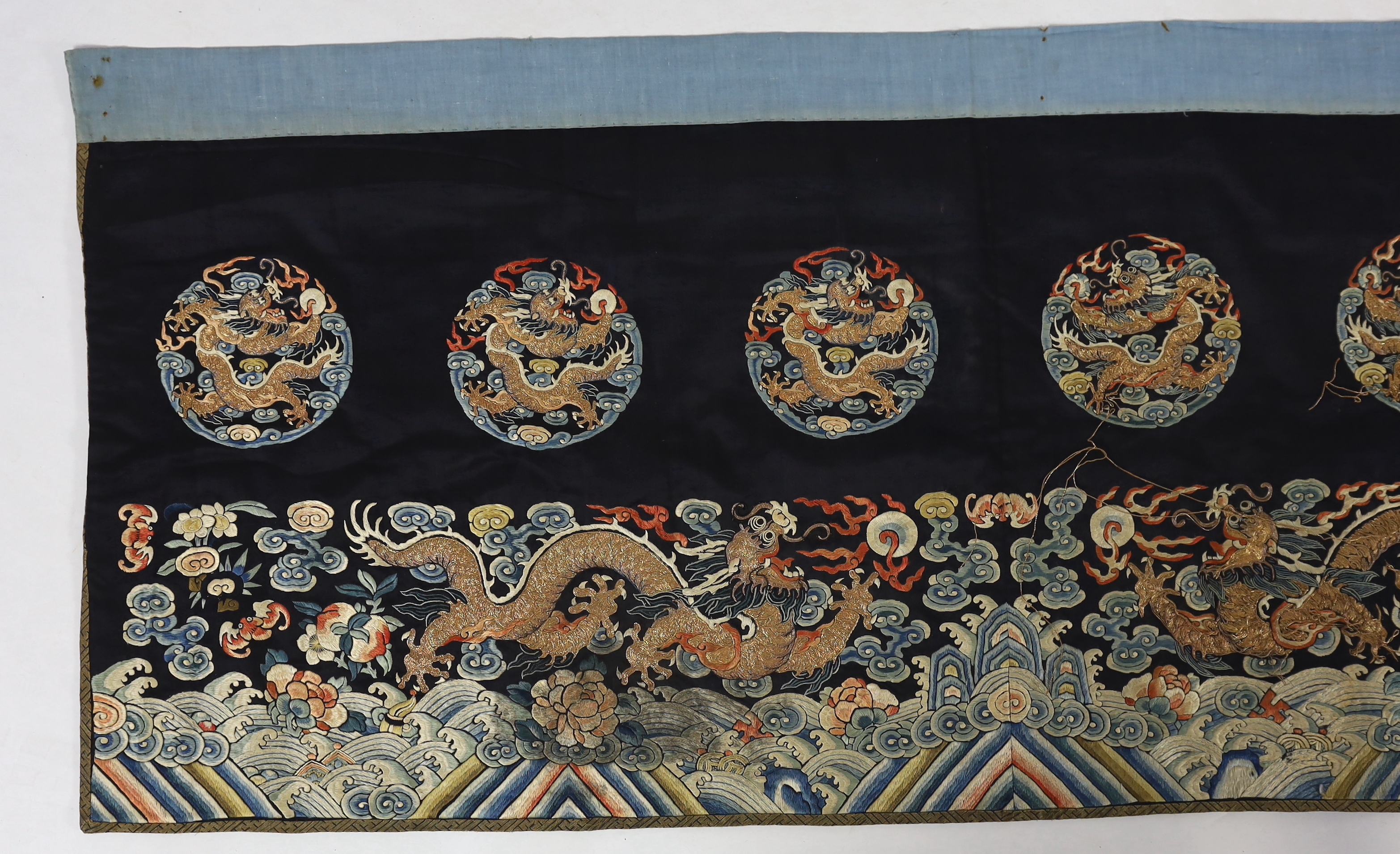 A Chinese embroidered silk 'dragon' table frontal, 19th century, damage